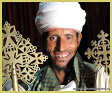 An Ethiopian Coptic Christian priest displaying the distinctive crosses of ancient Ethiopia at one of the rock-hewn churches of Lalibela (a UNESCO world heritage site)