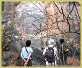 Visitors viewing one of the most impressive rock-art galleries in the Tsodilo hills world heritage site - Botswana 