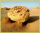 Wind-sculpted sandstone block lying on the desert floor at Wadi Al Hitan (Whale Valley) world heritage site in the western deserts of Egypt